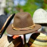 a vibrant display of fashionable fedoras stacked outdoors. perfect for sun protection and style. 35185 scaled